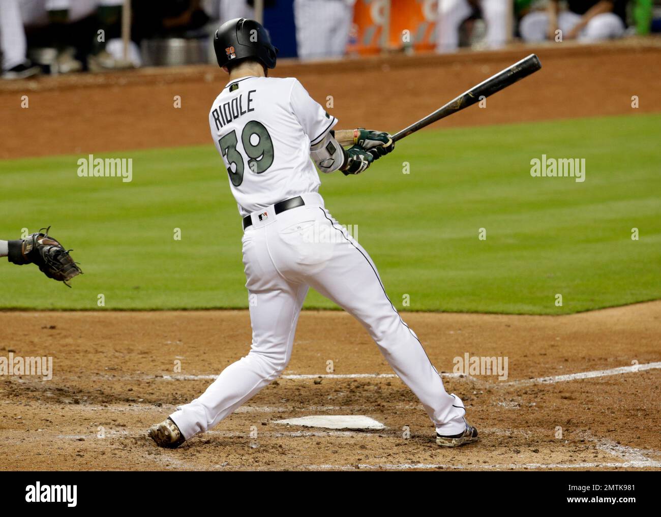 Miami Marlins' JT Riddle (39) hits an RBI-double to score Christian ...