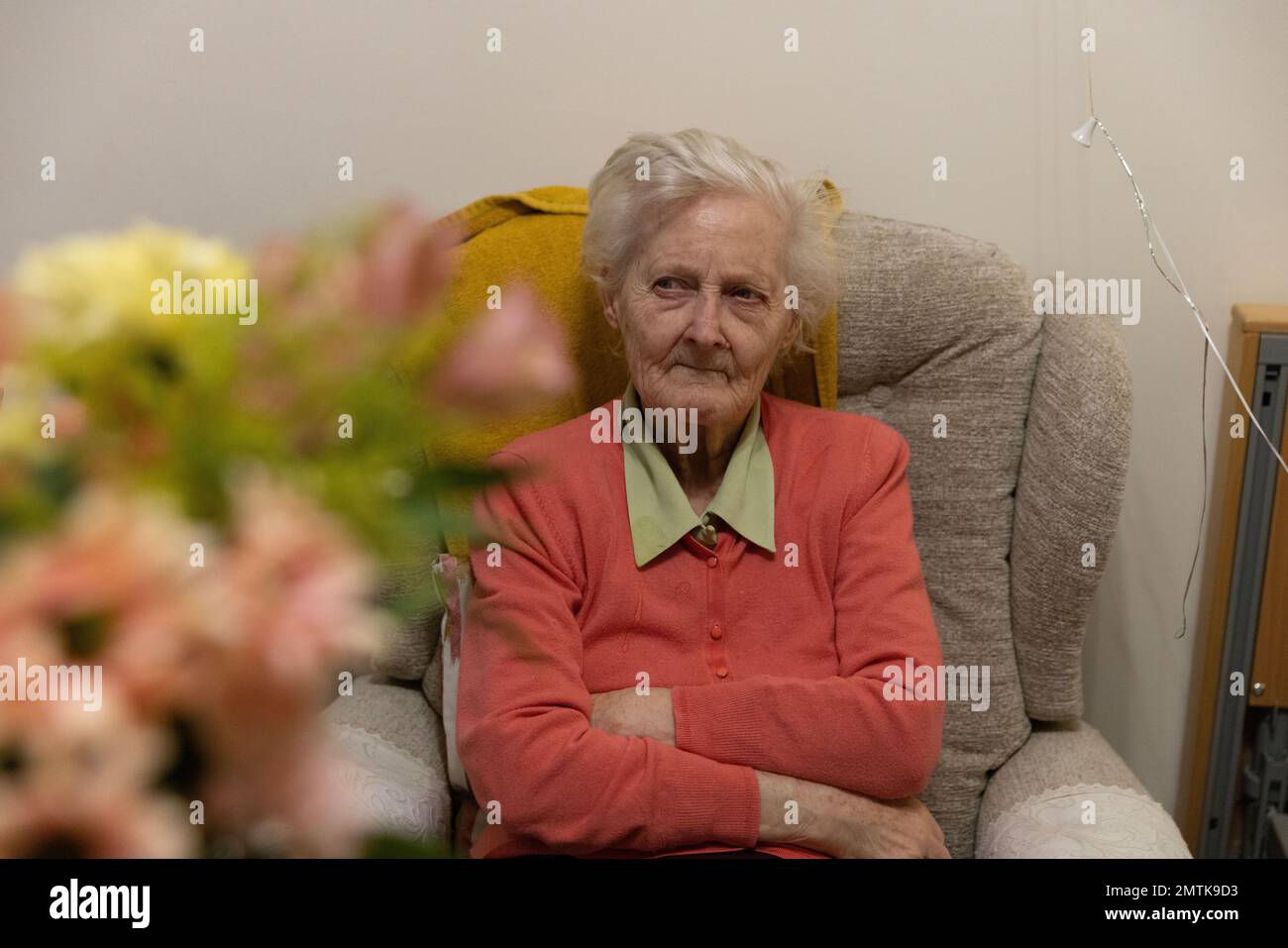 Elderly woman in her eighties living in a residents nursing home bedroom, England, UK Stock Photo