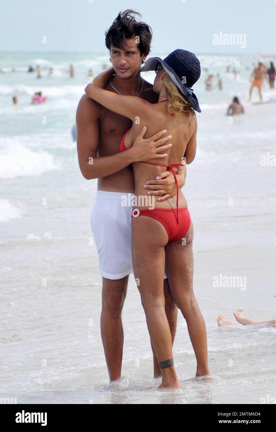 Former Playboy model Shauna Sand enjoys another day at the beach with her  new young tanned boyfriend. Shauna and her new beau played around in the  ocean and later laid in the