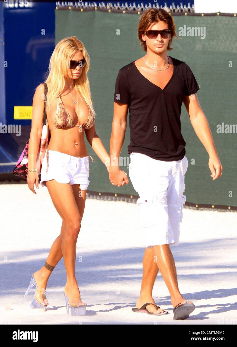 Former Playboy Playmate Shauna Sand carries a Barbie handbag and wears her  lucite heels as she takes a morning stroll on the beach with new husband  Laurent. Shauna looked to be walking
