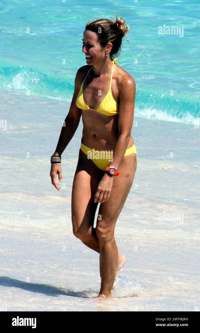 Rocker Sheryl crow sports a yellow bikini as she frolics in the