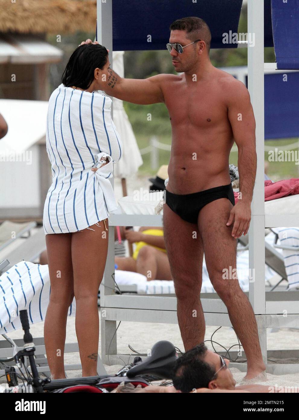 Diego Simeone and wife Carolina Baldini show off their toned bodies on the  beach. Miami, FL. 7/17/10 Stock Photo - Alamy