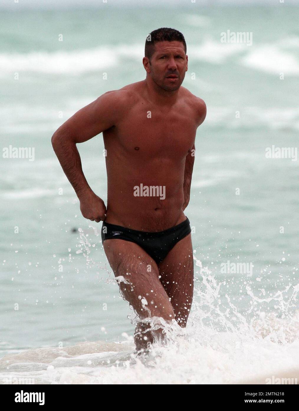 Diego Simeone and wife Carolina Baldini show off their toned bodies on the  beach. Miami, FL. 7/17/10 Stock Photo - Alamy