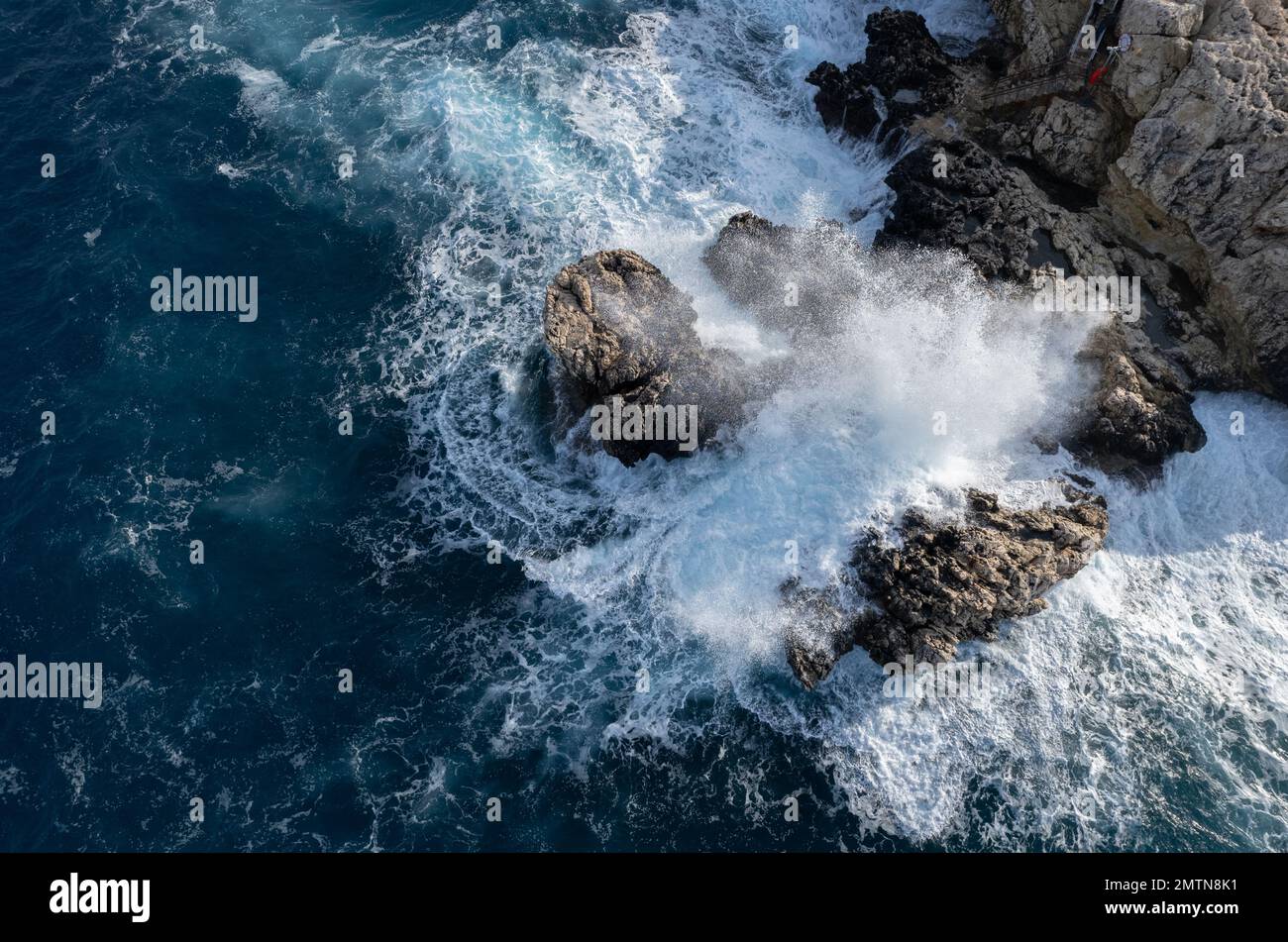 Drone aerial of rocky coast and stormy waves. Seascape windy waves. Stormy sea. Nature background. Cape Greko Cyprus Stock Photo