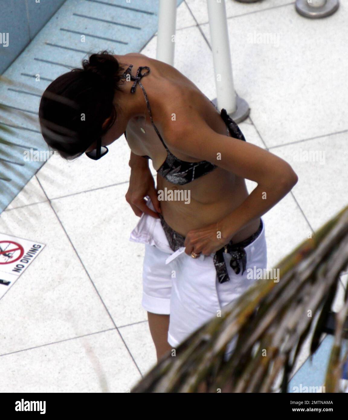 EXCLUSIVE!! A very skinny looking Katie Holmes enjoyed an afternoon dip in  her hotel pool with daughter Suri. The two had fun playing and swimming  with a little friend. Miami Beach, Fl.
