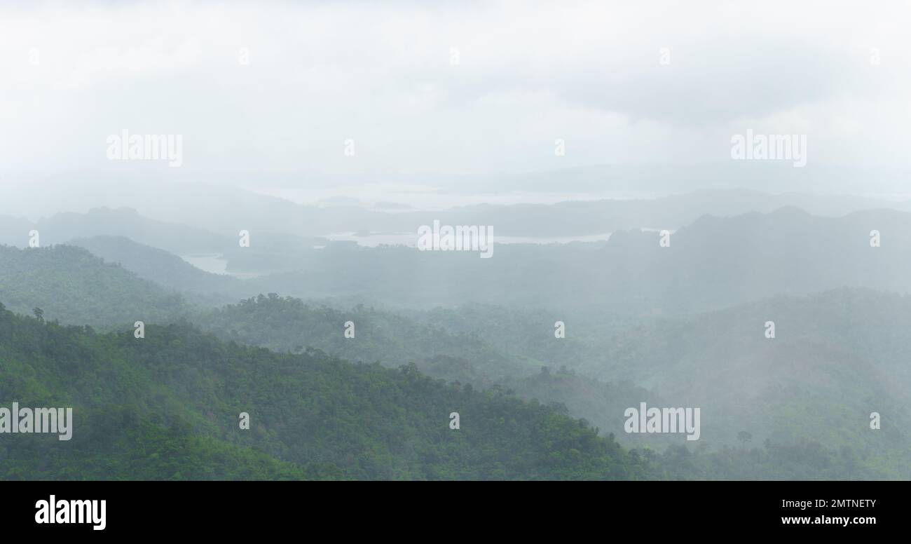 rainstorm shower on high mountain and lake overcast fog panorama