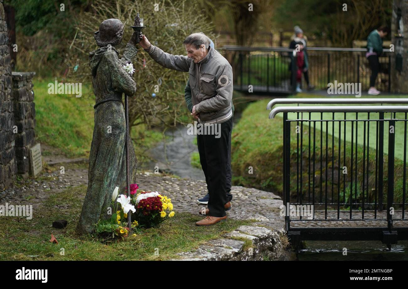 A man touches a statue of St. Brigid at St Brigid's holy well in Co Kildare. February 1st marks St Brigid's Day which is seen by many in Ireland as the first day of Spring. Picture date: Wednesday February 1, 2023. Stock Photo