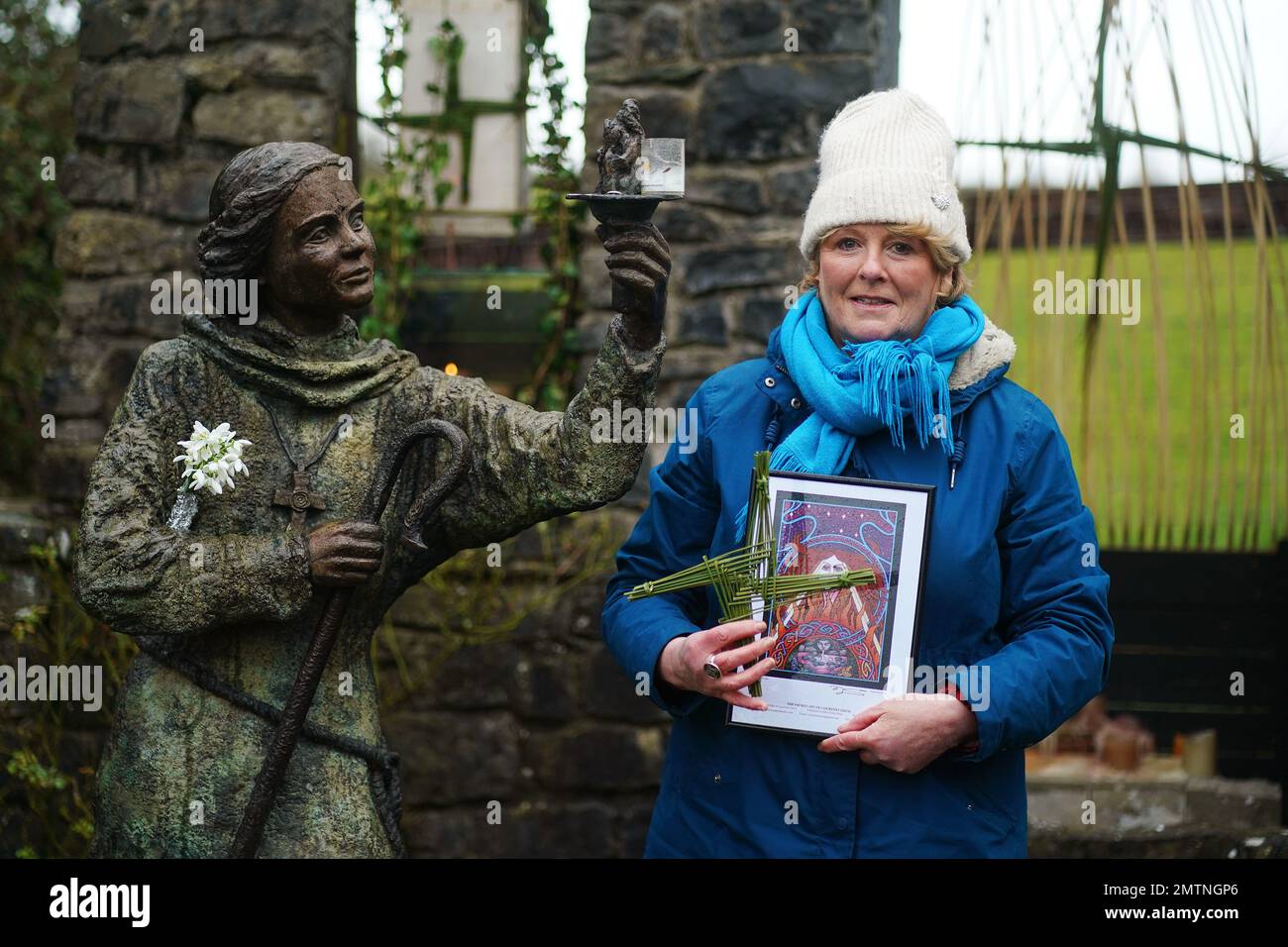 Nora Creed stands beside a statue of St. Brigid ahead of conducting a ceremony to embrace the devine feminine and honour the saint at St Brigid's holy well in Co Kildare. February 1st marks St Brigid's Day which is seen by many in Ireland as the first day of Spring. Picture date: Wednesday February 1, 2023. Stock Photo
