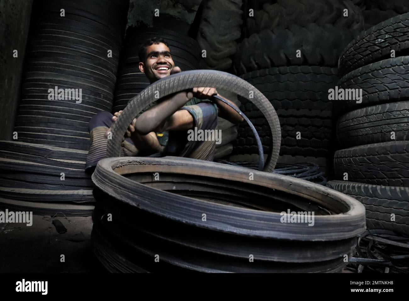 Dhaka, Dhaka, Bangladesh. 1st Feb, 2023. A worker cuts old car tires