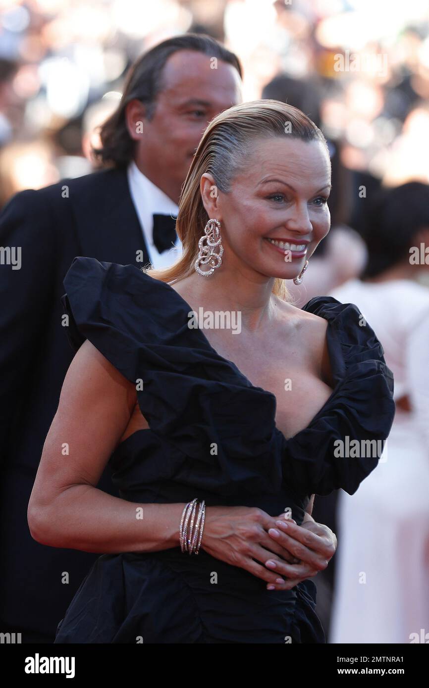 Pamela Anderson poses for photographers upon arrival at the screening