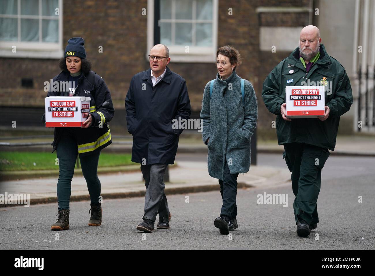 Paul Nowak, general secretary of the Trades Union Congress (TUC), is joined by a representative of the Fire Brigades Union and the NHS Ambulance Service as they walk to 10 Downing Street, London, to hand in a mass petition against the Government's controversial plans for a new law on minimum service levels during strikes. Picture date: Wednesday February 1, 2023. Stock Photo