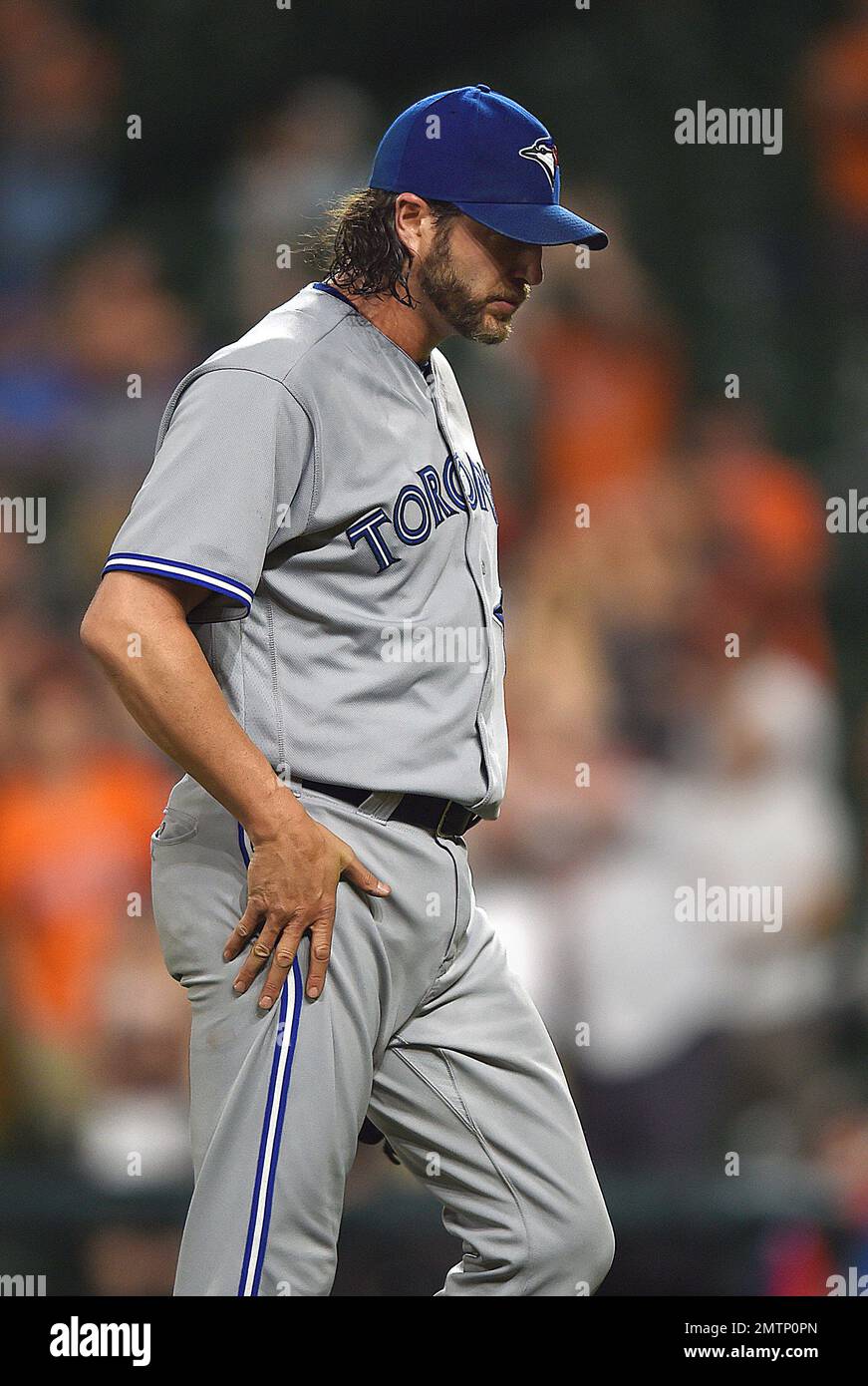 Toronto Blue Jays pitcher Jason Grilli walks off the field after giving up  the game-winning home run to Baltimore Orioles' Wellington Castillo during  the 10th inning of a baseball game, Friday, May