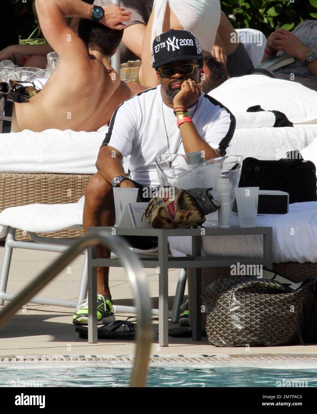 Spike Lee and his son Jackson play a game of catch by the pool of their  luxury hotel, the Fontainebleau Miami Beach, FL. 12/31/09 Stock Photo -  Alamy