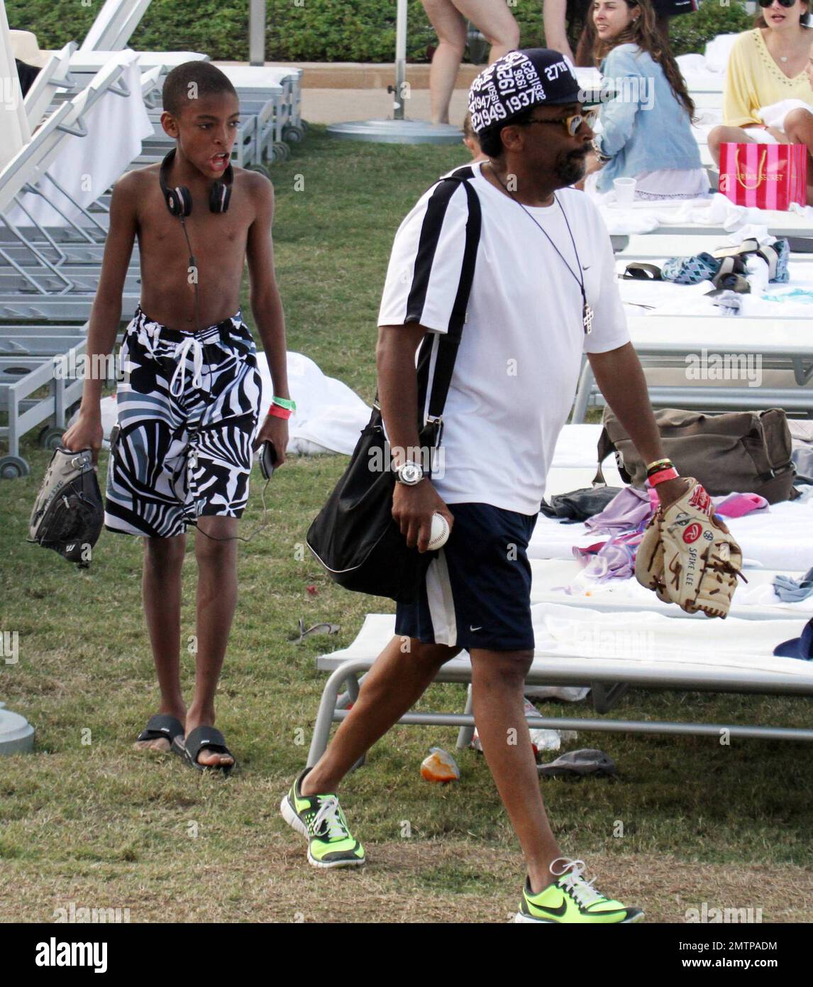Spike Lee and his son Jackson play a game of catch by the pool of their  luxury hotel, the Fontainebleau Miami Beach, FL. 12/31/09 Stock Photo -  Alamy