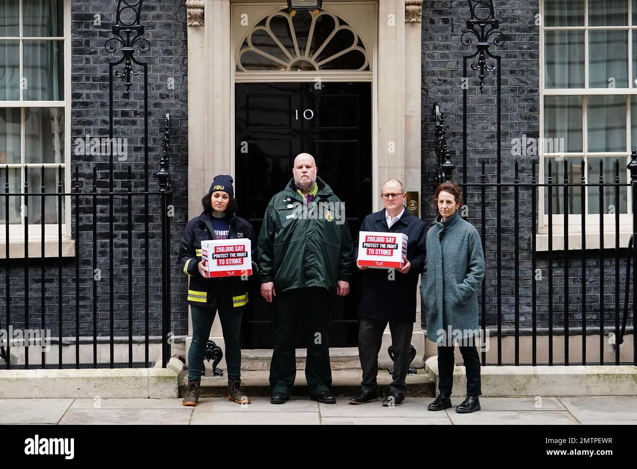 Paul Nowak (centre), general secretary of the Trades Union Congress (TUC), is joined by a representative of the Fire Brigades Union and the NHS Ambulance Service as they stand outside 10 Downing Street, London, to hand in a mass petition against the Government's controversial plans for a new law on minimum service levels during strikes. Picture date: Wednesday February 1, 2023. Stock Photo