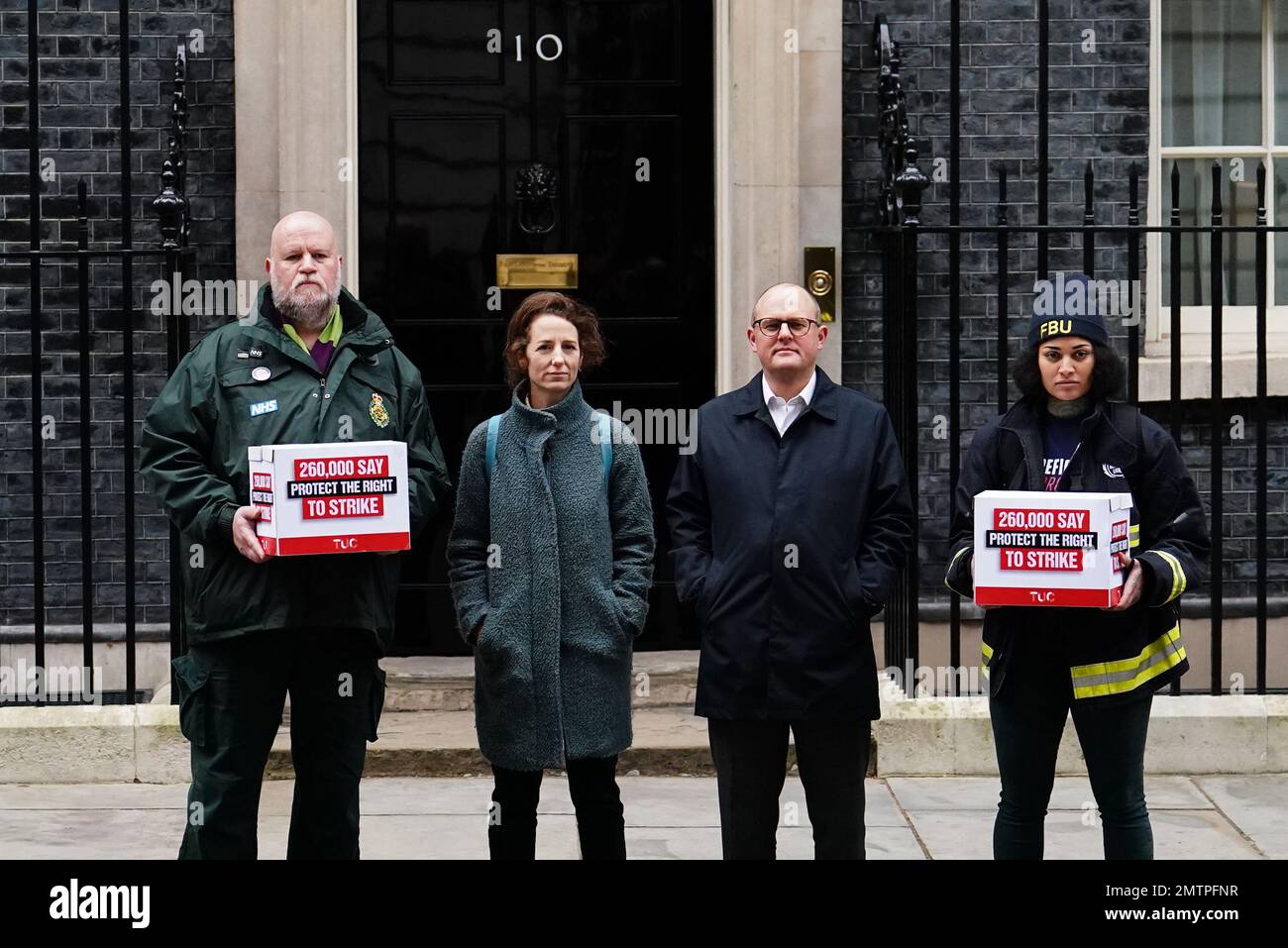 Paul Nowak (centre-right), general secretary of the Trades Union Congress (TUC), is joined by a representative of the Fire Brigades Union and the NHS Ambulance Service as they stand outside 10 Downing Street, London, to hand in a mass petition against the Government's controversial plans for a new law on minimum service levels during strikes. Picture date: Wednesday February 1, 2023. Stock Photo