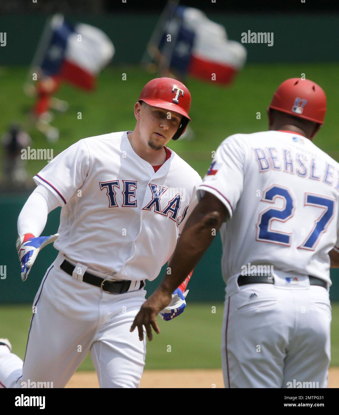 Texas Rangers' Ryan Rua, left, is congratulated by third base coach ...
