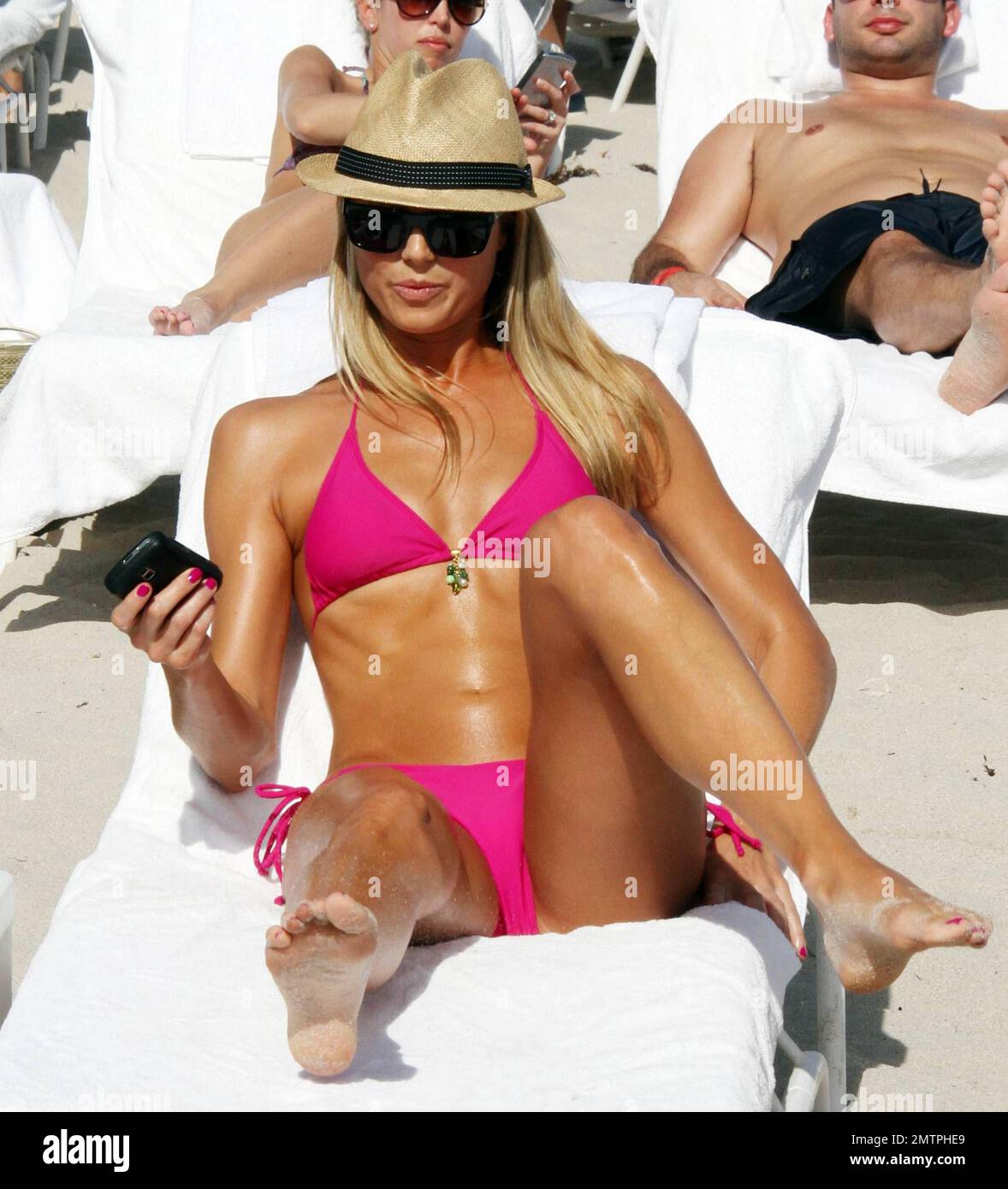 Stacy Keibler flaunts her perfect figure in a tiny hot pink bikini  beachside at her luxury hotel, the Fontainebleau Miami Beach before  lunching poolside with Kevin Connolly. Miami, FL. 12/31/09 Stock Photo -