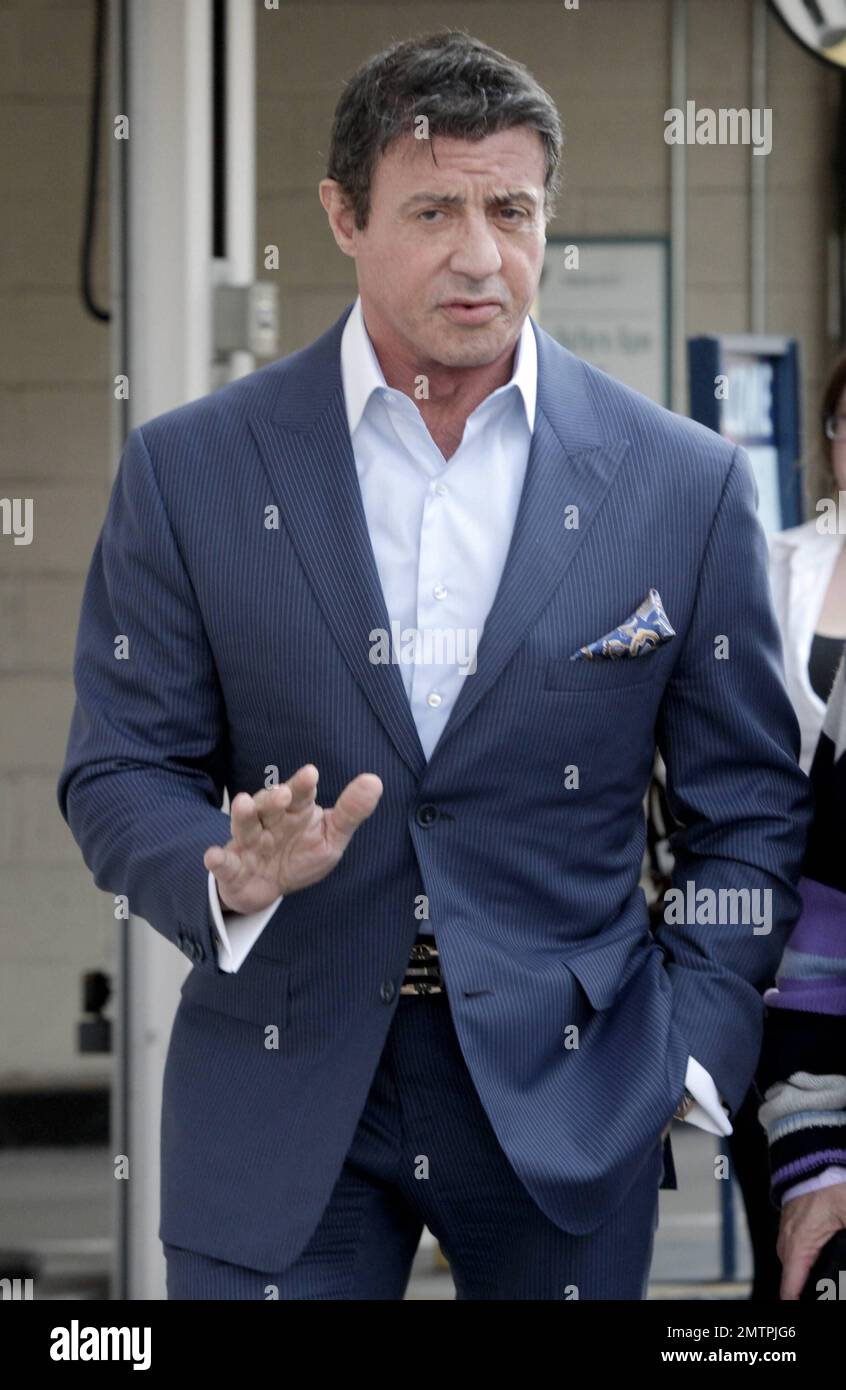 Actor Sylvester Stallone was seen in blue suit out in Beverly Hills. It's been reported that Stallone will be returning with Rocky Balboa but this time as a musical. Stallone will be co-producing 'Rocky:The Musical' based on the 1976 movie that launched his career. Inspired by the success of 'Spider-Man:Turn Off the Dark,' Stallone and company are reframing the underdog boxing tale as a love story between Rocky and Adrian. 65 year old Sylvester won't be putting on the gloves this time, he'll be active behind the scenes with producer Kevin King Templeton from Stallone's Rogue Marble production Stock Photo