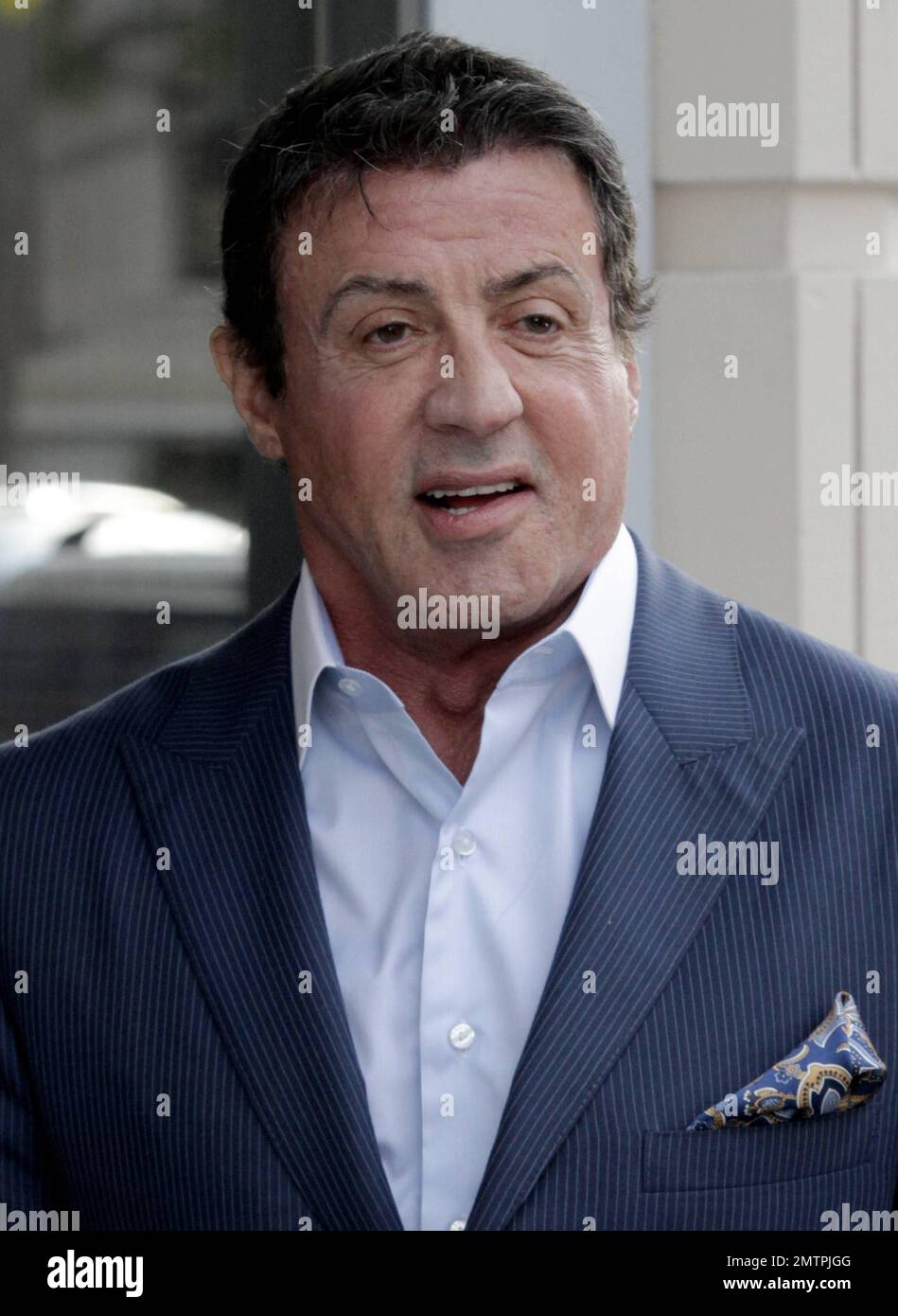 Actor Sylvester Stallone was seen in blue suit out in Beverly Hills. It's been reported that Stallone will be returning with Rocky Balboa but this time as a musical. Stallone will be co-producing 'Rocky:The Musical' based on the 1976 movie that launched his career. Inspired by the success of 'Spider-Man:Turn Off the Dark,' Stallone and company are reframing the underdog boxing tale as a love story between Rocky and Adrian. 65 year old Sylvester won't be putting on the gloves this time, he'll be active behind the scenes with producer Kevin King Templeton from Stallone's Rogue Marble production Stock Photo