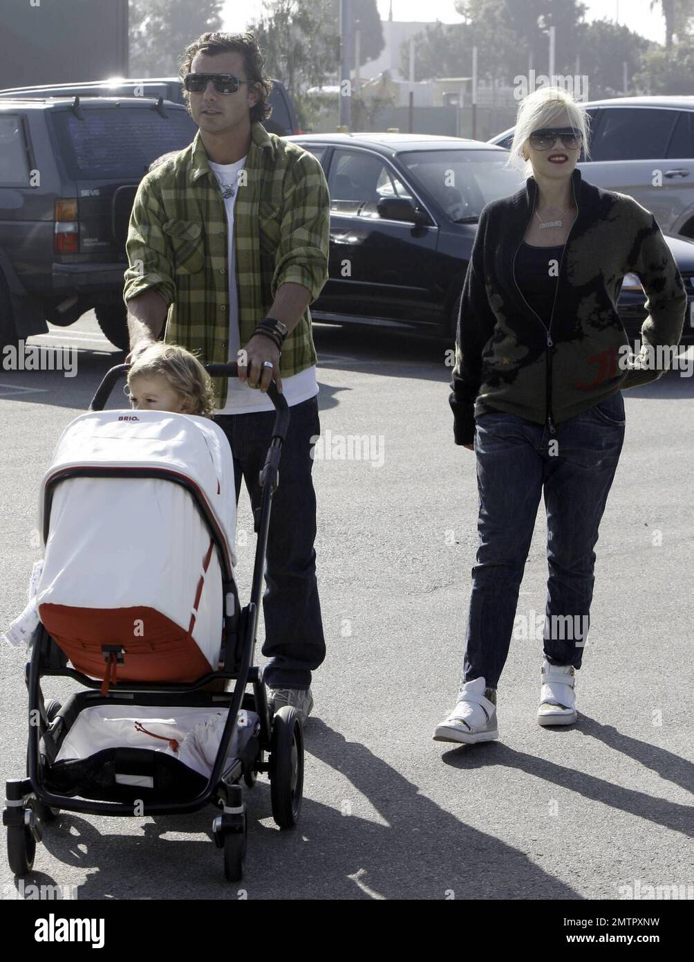 Gwen Stefani and Gavin Rossdale take sons Kingston and baby Zuma on a family shopping outing, stopping in at a local gourmet food store and at a Lakeshore Learning Materials store nearby. Little Zuma napped in his stroller while Kingston rode along, standing on a platform attached to the back. After shopping at Lakeshore, Gavin pushed a cart overflowing with bags of goodies from Lakeshore as Gwen took care of getting the kids back to the car. Los Angeles, CA. 11/29/08. Stock Photo