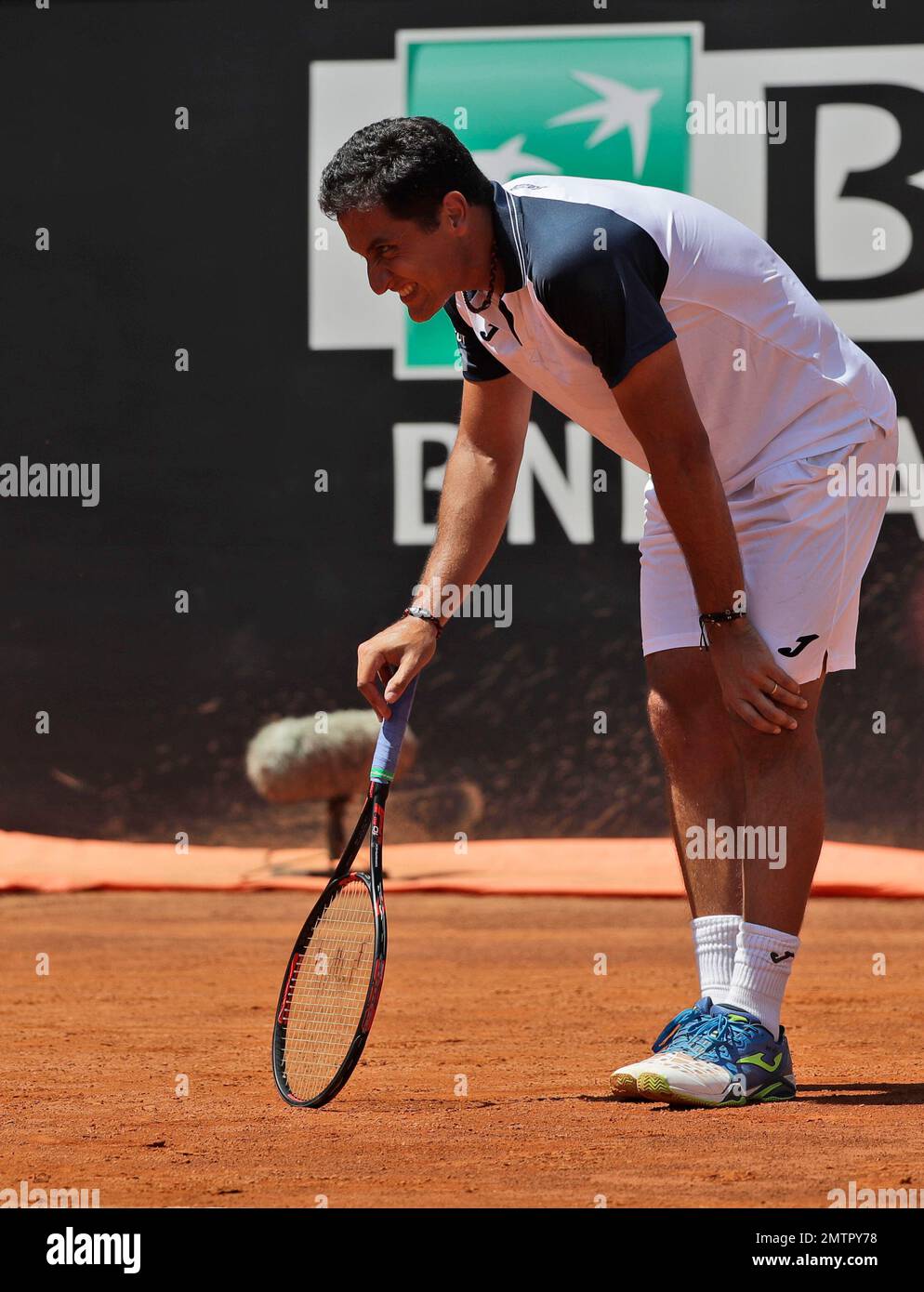 Spain's Nicolas Almagro holds his knee as he grimaces in pain during his  match against Rafael Nadal, at the Italian Open tennis tournament, in Rome,  Wednesday, May 17, 2017. (AP Photo/Alessandra Tarantino