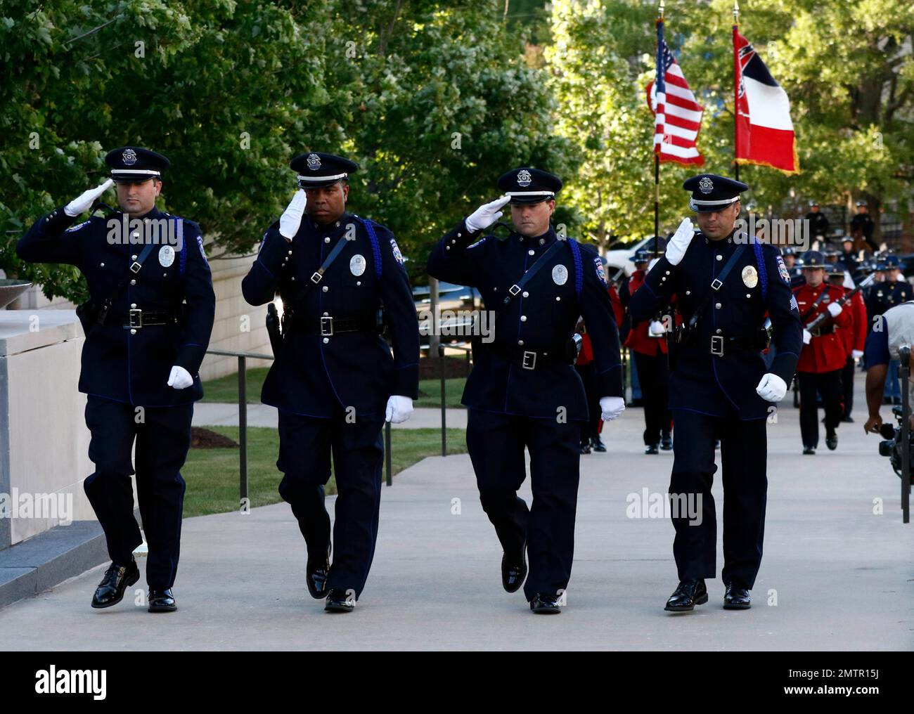 Members of the Gulfport Police Department honor guard salute as they