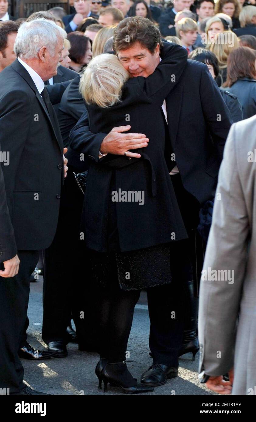 Stephen Gately's mother Margaret is comforted by friends and family as paul bearers Ronan Keating and Boyzone members Mikey Graham, Shane Lynch and Keith Duffy look on after Gately's funeral at St. Laurence O'Toole's Church. A founding member of Ireland's first boy band, Boyzone, Stephen Gately was found dead at the age of 33 while on holiday in Majorca. It's reported that an autopsy revealed that Stephen died from acute pulmonary oedema, a buildup of fluid in his lungs. Gately was a champion of gay rights after coming out in 1999 and entered into a civil union with Andrew Cowles in 2006. Dubl Stock Photo
