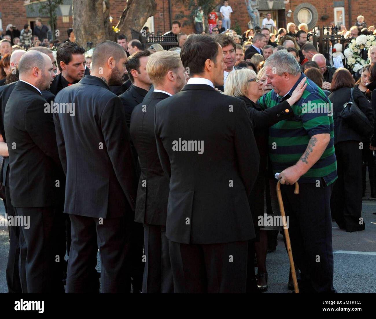 Stephen Gately's mother Margaret is comforted by friends and family as paul bearers Ronan Keating and Boyzone members Mikey Graham, Shane Lynch and Keith Duffy look on after Gately's funeral at St. Laurence O'Toole's Church. A founding member of Ireland's first boy band, Boyzone, Stephen Gately was found dead at the age of 33 while on holiday in Majorca. It's reported that an autopsy revealed that Stephen died from acute pulmonary oedema, a buildup of fluid in his lungs. Gately was a champion of gay rights after coming out in 1999 and entered into a civil union with Andrew Cowles in 2006. Dubl Stock Photo