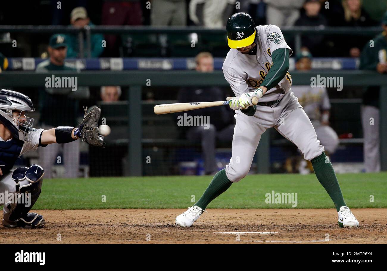 Oakland Athletics' Adam Rosales watches the ball go past and into the