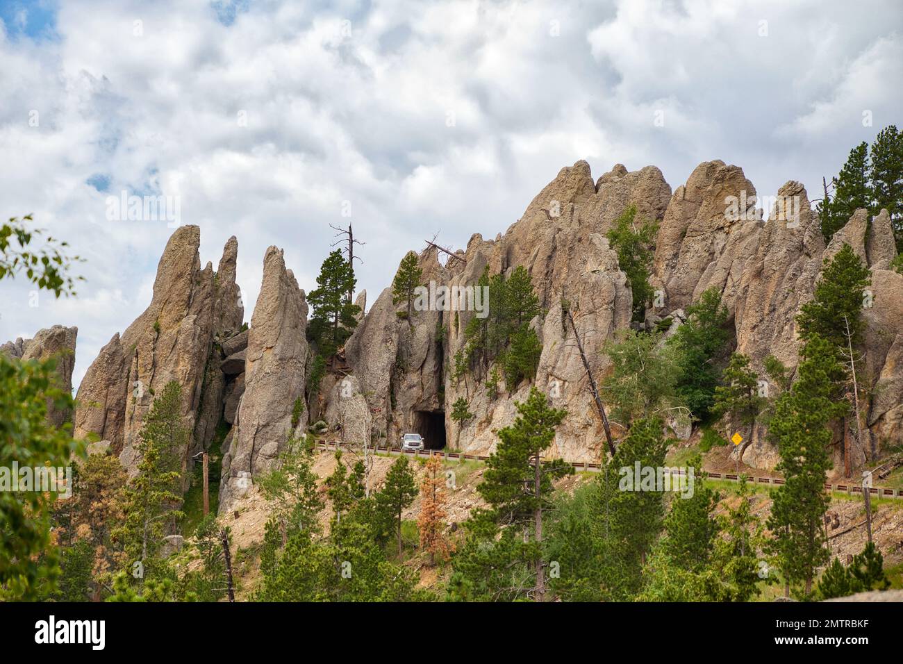 A Narrow Vehicle Entrance Through A Rock Cave Along Needles Highway In 