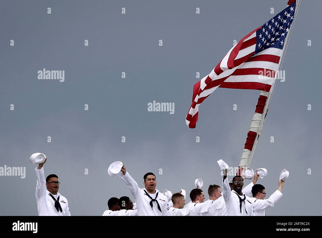 The United States Navy sailors wave from aboard the guided missile ...