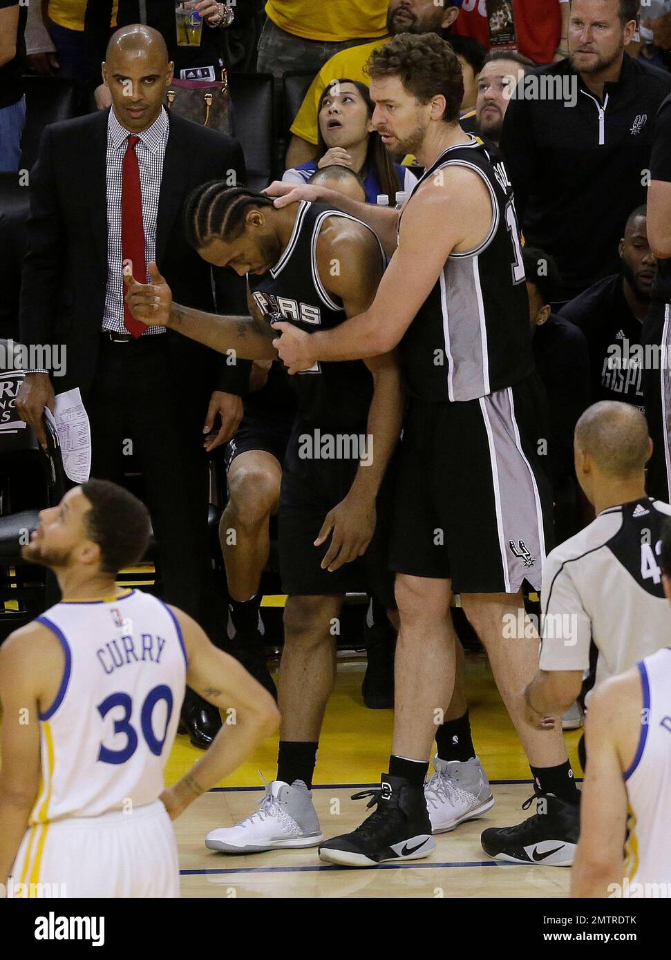 San Antonio Spurs forward Kawhi Leonard (2) congratulates Spurs center Tim  Duncan, center, with Spurs forward Boris Diaw, right, of France for picking  up a foul after making a shot against the