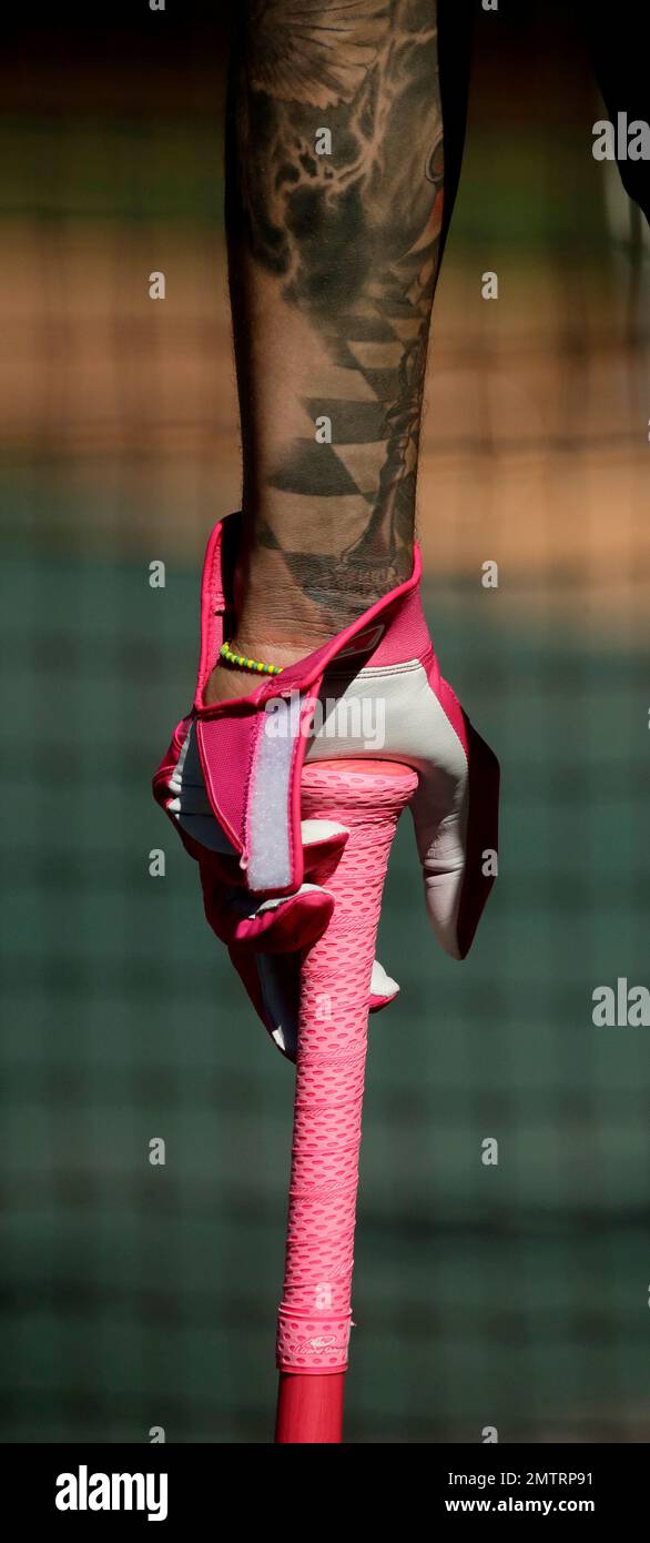 Baltimore Orioles' Manny Machado wears pink batting gloves and bats in  honor of Mother's Day as he takes batting practice before a baseball game  against the Kansas City Royals, Saturday, May 13