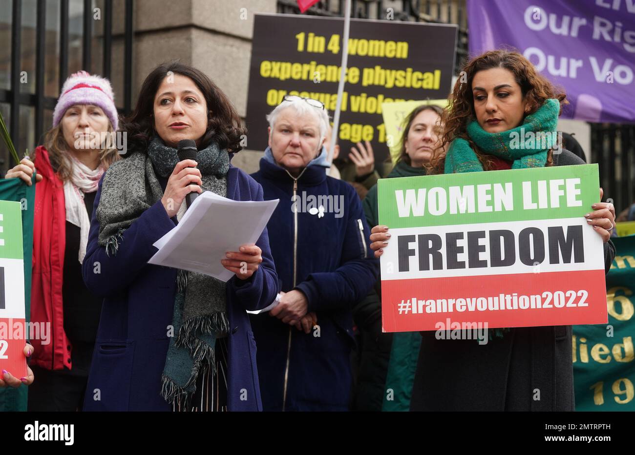 Roja Fazaeli (second left), an associate professor in Islamic civilisations at Trinity, speaking at a St Brigid's Day rally outside Leinster House, Dublin, calling on the Government to take action in addressing violence against women in Ireland. The rally was held to coincide with St Brigid’s Day, with speakers asking that women be protected in the spirit of the Celtic goddess and Christian saint Brigid, who is associated with healing. Picture date: Wednesday February 1, 2023. Stock Photo