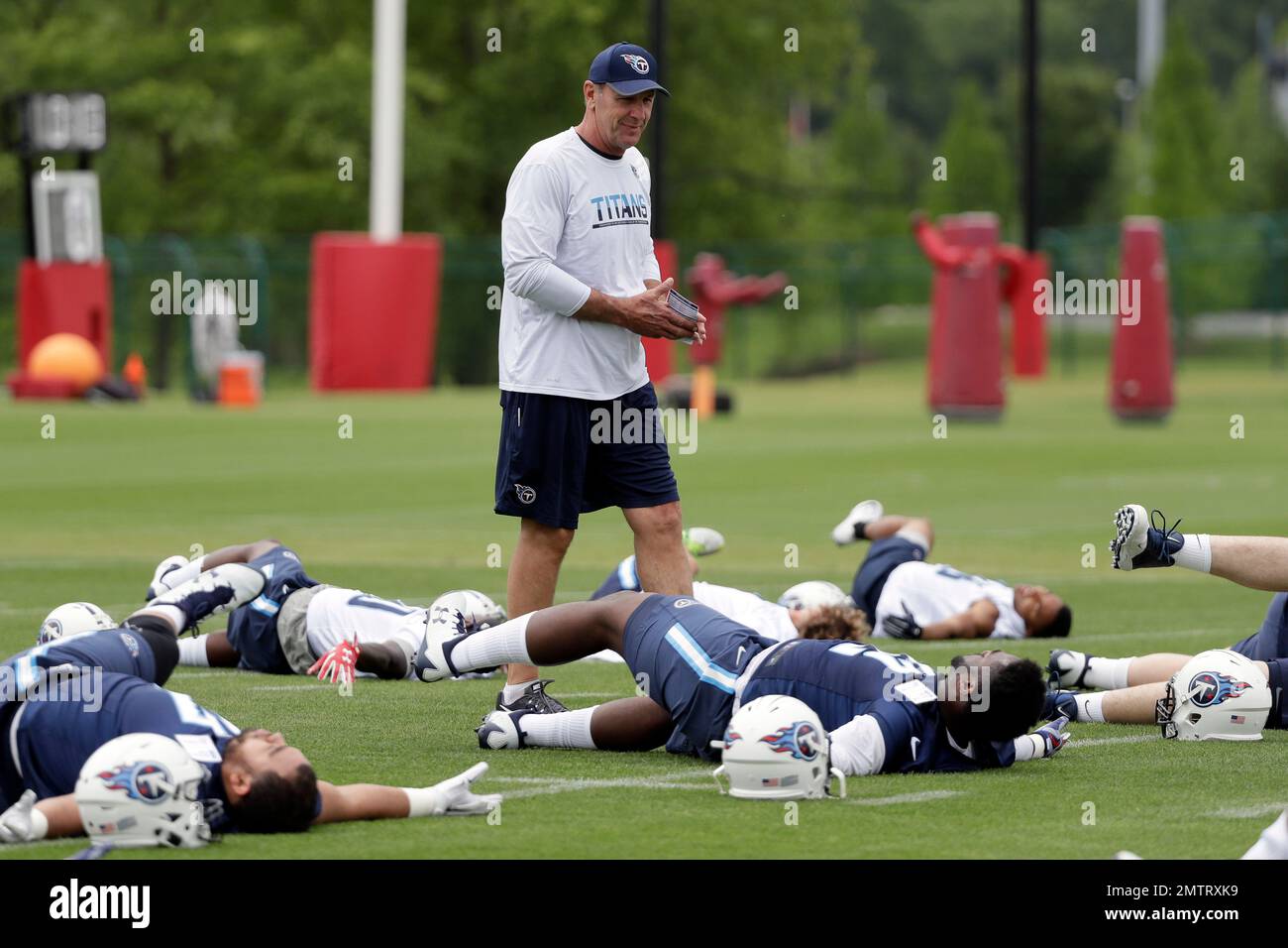 Tennessee Titans head coach Mike Mularkey watches as players warm up