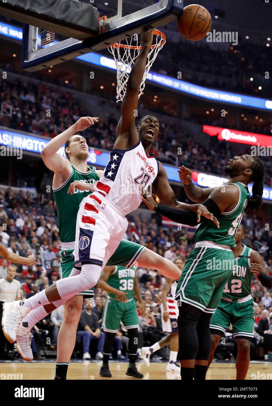 Washington Wizards center Ian Mahinmi (28) is fouled as he tries to shoot by Boston Celtics center Kelly Olynyk (41) with Celtics forward Jae Crowder (99) nearby, during the first half of Game 6 of an NBA basketball second-round playoff series, Friday, May 12, 2017, in Washington. (AP Photo/Alex Brandon) Stock Photo