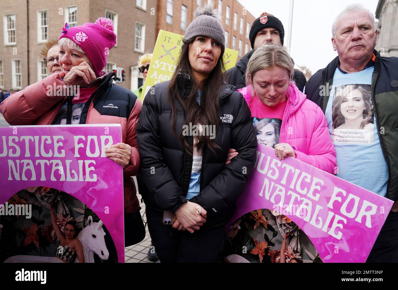 Family members of murder victim Natalie McNally Gemma Doran (centre), Bernie McNally (left) and Hollie Donnelly (second right) attend a St Brigid's Day rally outside Leinster House, Dublin, calling on the Government to take action in addressing violence against women in Ireland. The rally was held to coincide with St Brigid’s Day, with speakers asking that women be protected in the spirit of the Celtic goddess and Christian saint Brigid, who is associated with healing. Picture date: Wednesday February 1, 2023. Stock Photo
