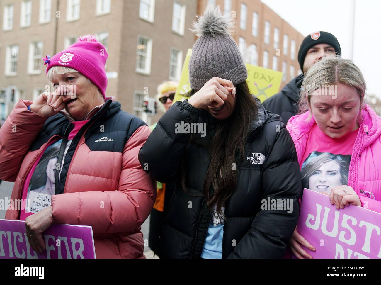 Family members of murder victim Natalie McNally Gemma Doran (centre), Bernie McNally (left) and Hollie Donnelly (right) attend a St Brigid's Day rally outside Leinster House, Dublin, calling on the Government to take action in addressing violence against women in Ireland. The rally was held to coincide with St Brigid’s Day, with speakers asking that women be protected in the spirit of the Celtic goddess and Christian saint Brigid, who is associated with healing. Picture date: Wednesday February 1, 2023. Stock Photo
