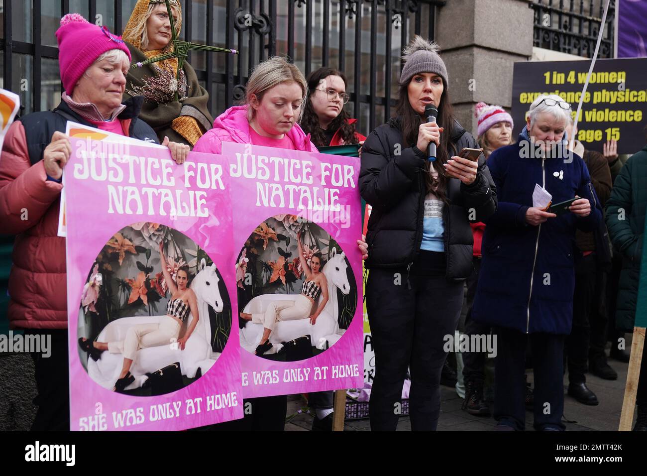 Family members of murder victim Natalie McNally Gemma Doran (centre right), Bernie McNally (left) and Hollie Donnelly (centre left) attend a St Brigid's Day rally outside Leinster House, Dublin, calling on the Government to take action in addressing violence against women in Ireland. The rally was held to coincide with St Brigid’s Day, with speakers asking that women be protected in the spirit of the Celtic goddess and Christian saint Brigid, who is associated with healing. Picture date: Wednesday February 1, 2023. Stock Photo