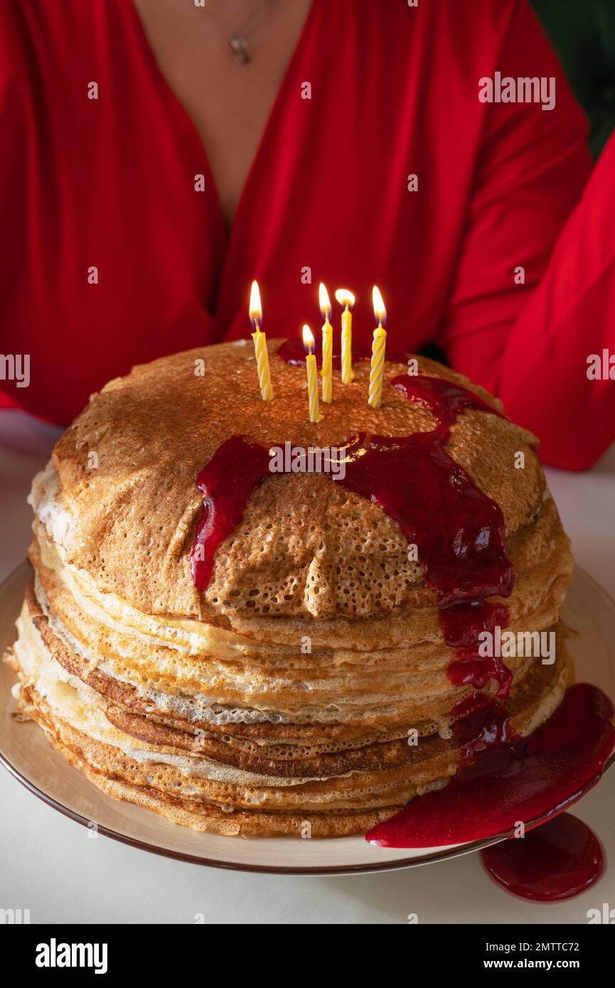 Pancakes with berries jam and 5 candles Stock Photo