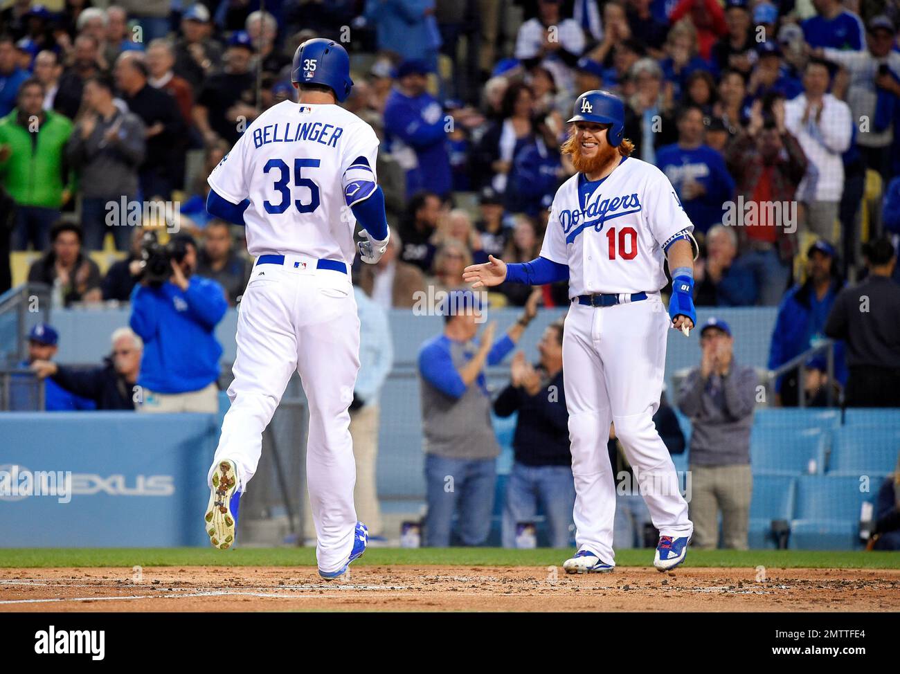 FILE - In this June 20, 2017, file photo, Los Angeles Dodgers' Cody  Bellinger, right, and Justin Turner celebrate Bellinger's two-run home run  during the first inning of a baseball game against