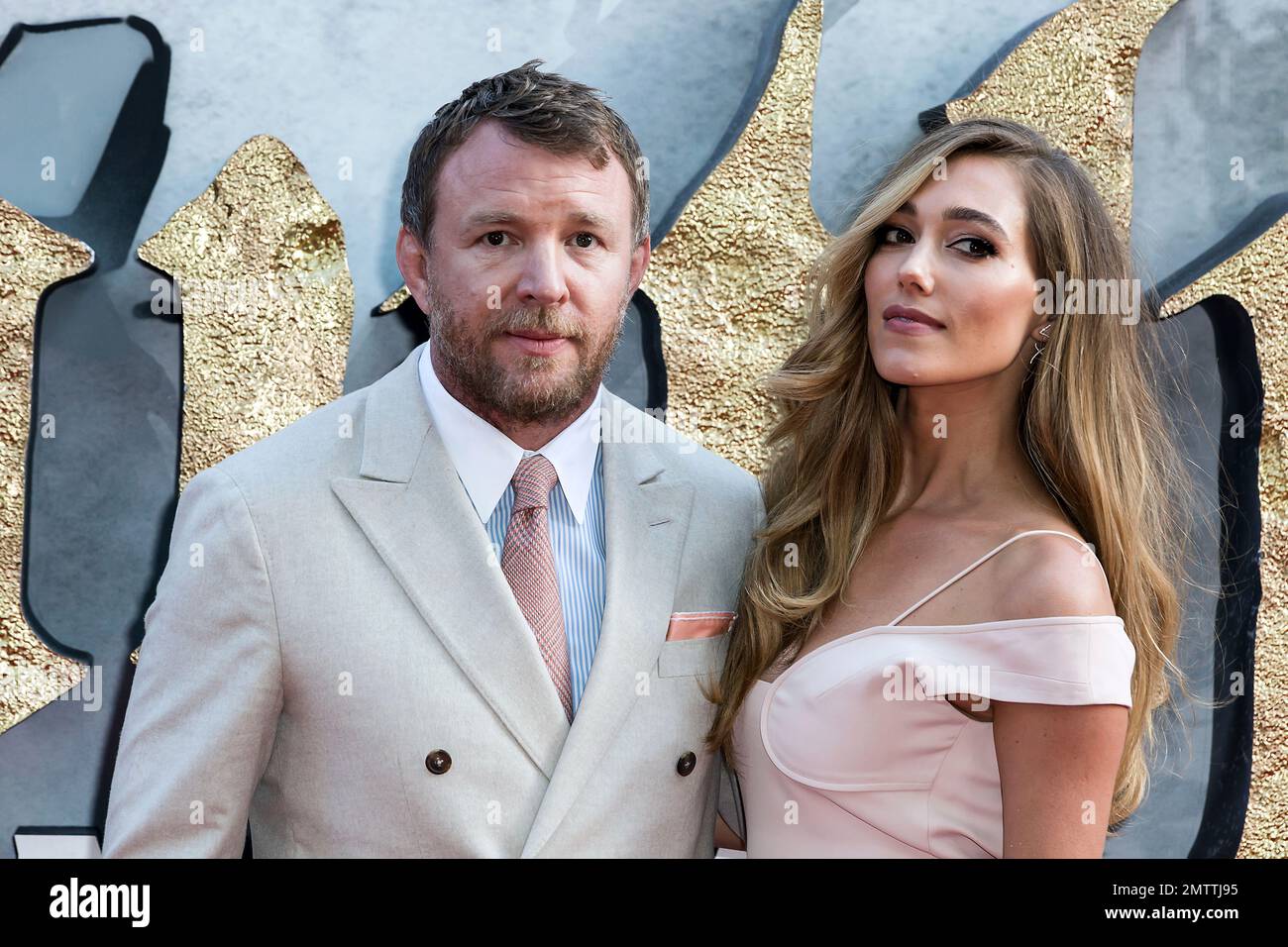 Director Guy Ritchie and partner Jacqui Ainsley pose for photographers ...