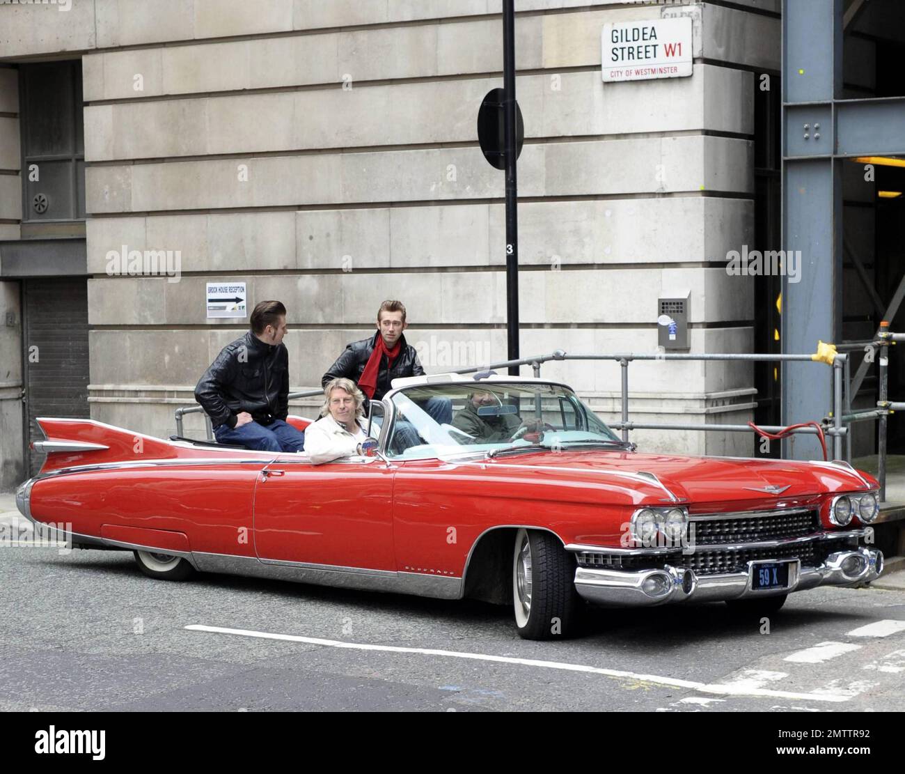 Berlin-bred rockabilly musicians The Baseballs pose in their classic red convertible Cadillac outside the BBC Radio 2 studios after promoting their new album Strike.  The trio, Sam, Digger and Basti, are known for covering popular songs and revamping them with a 50s-style rock twist.  According to reports the group also treated passersby to an impromptu version of Rihanna's song 'Umbrella'.  London, UK. 05/11/10. Stock Photo