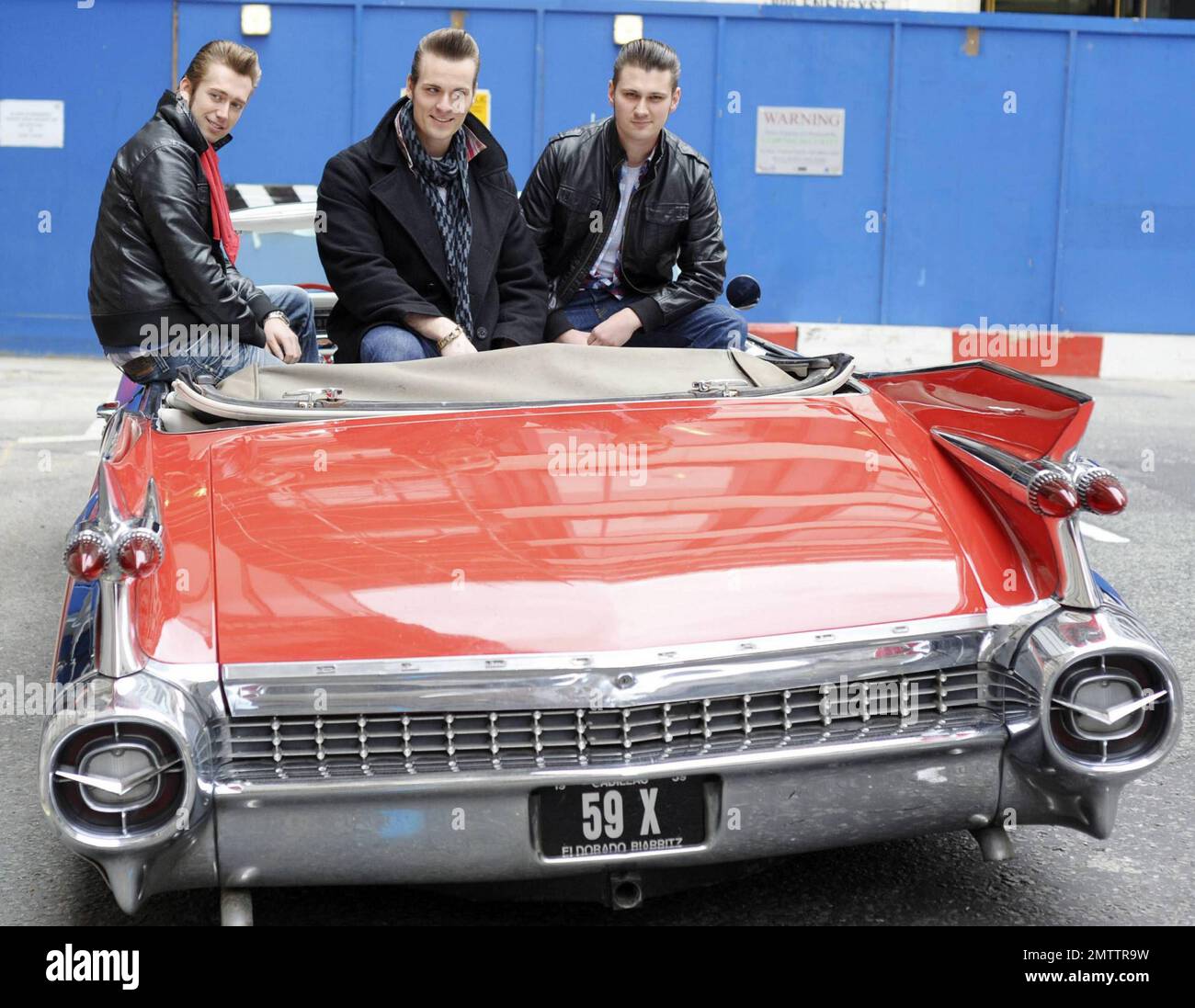 Berlin-bred rockabilly musicians The Baseballs pose in their classic red convertible Cadillac outside the BBC Radio 2 studios after promoting their new album Strike.  The trio, Sam, Digger and Basti, are known for covering popular songs and revamping them with a 50s-style rock twist.  According to reports the group also treated passersby to an impromptu version of Rihanna's song 'Umbrella'.  London, UK. 05/11/10.   . Stock Photo
