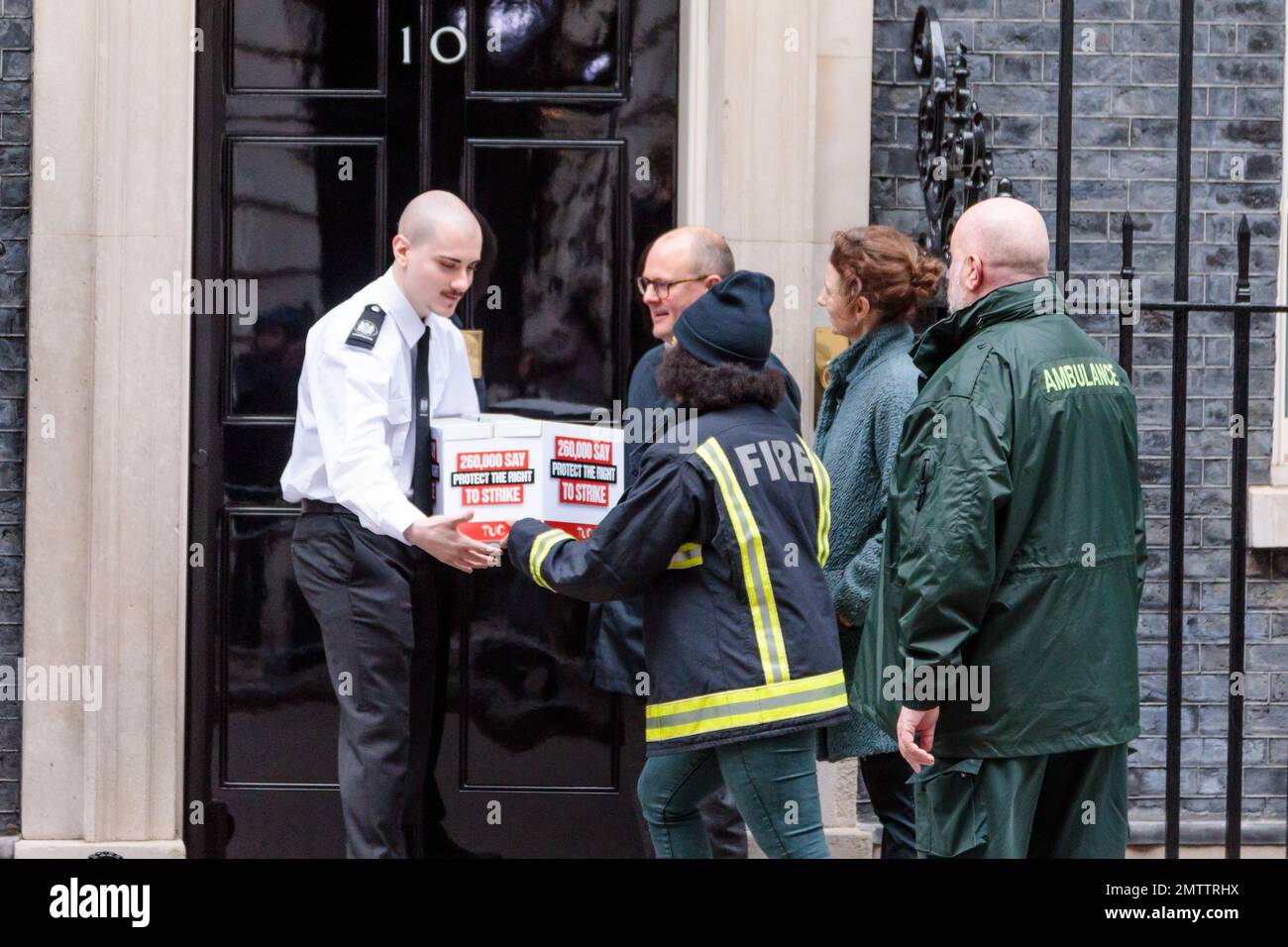 Downing Street, London, UK. 1st February 2023. Kacey LeGall, Fire Brigade Union, hands in a petition, signed by more than 200,000 people, opposing the new legislation on strikes, to Number 10 Downing Street.  Eddie Brand, Branch Secretary, Unison, London Ambulance Service,  Paul Nowak, General Secretary, TUC, Kate Bell, Assistant General Secretary, TUC, Eddie Brand, Branch Secretary, Unison, London Ambulance Service,        Photo by Amanda Rose/Alamy Live News Stock Photo