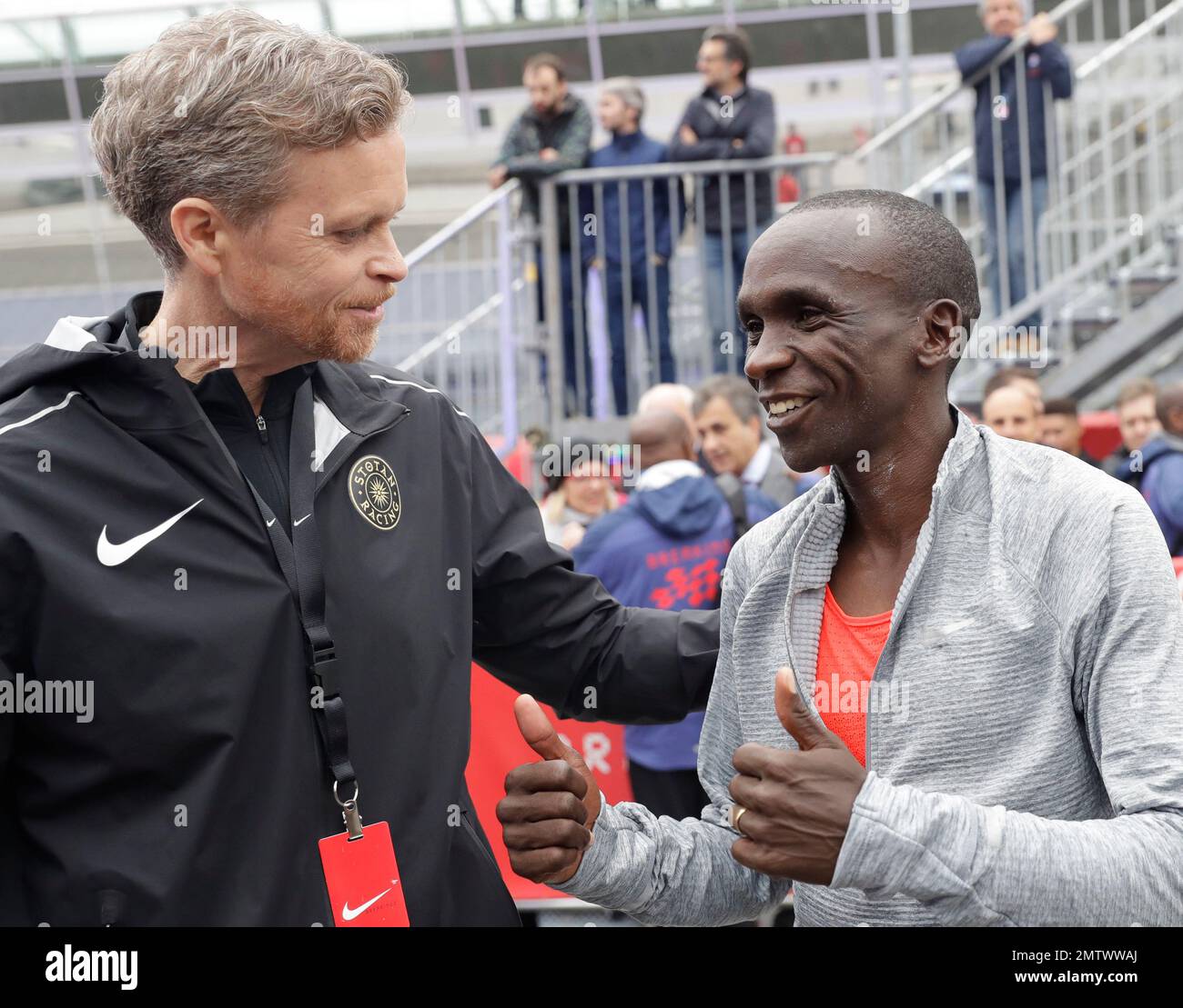 Olympic marathon champion Eliud Kipchoge, right, talks with Nike CEO and  President Mark Parker, , after crossing the finish line of a marathon at  the Monza Formula One racetrack, Italy, Saturday, May