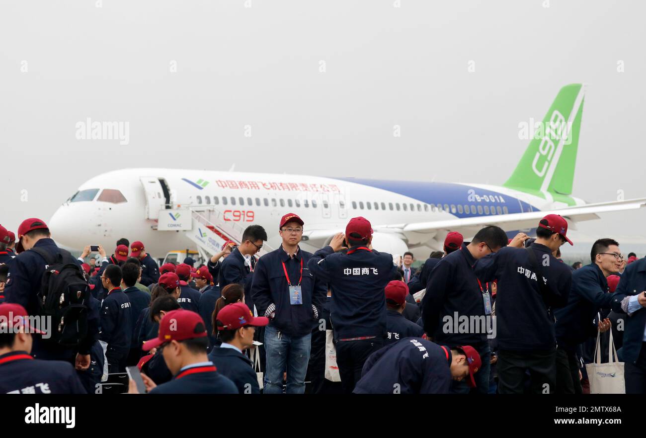 Attendees take photos in front of a Chinese C919 passenger jet after ...