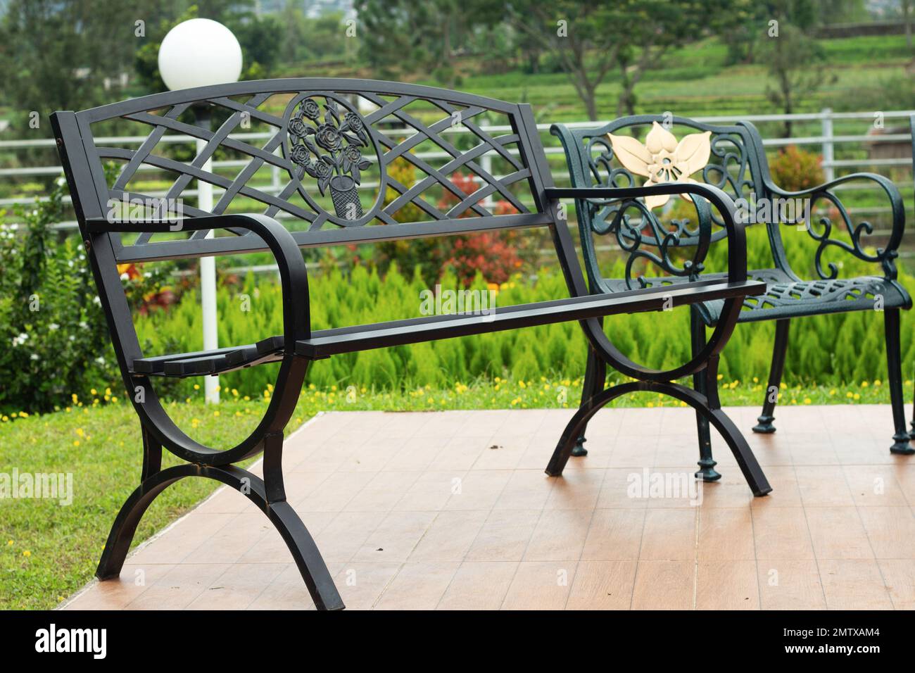 Metal garden bench in home garden stock photo alamy