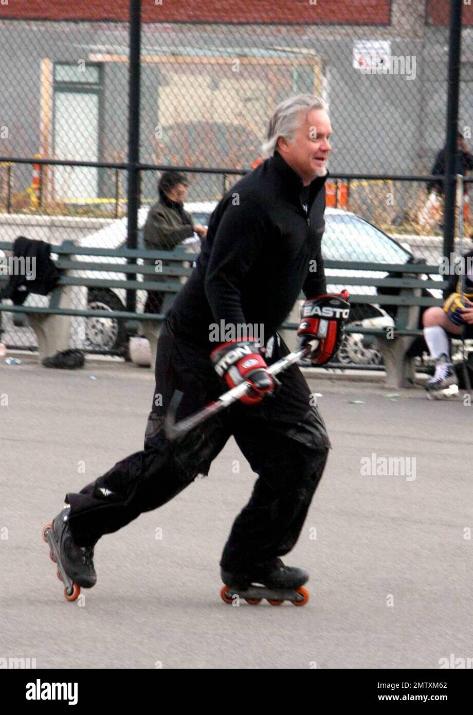 Actor Tim Robbins gets in a game of roller hockey with a group of